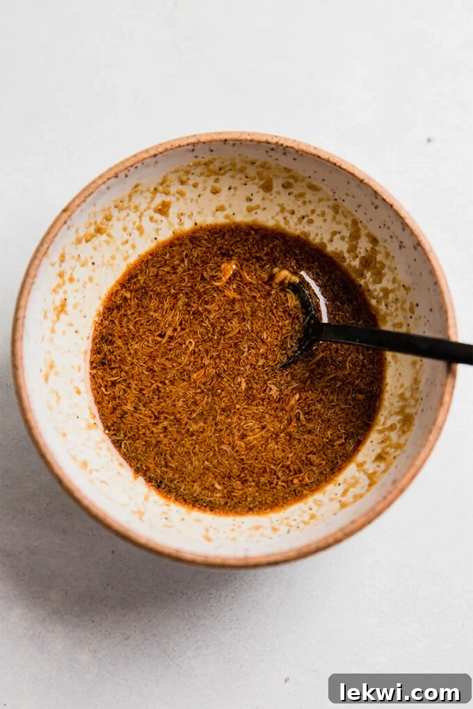 Spoon in a bowl of coconut amino sauce.
