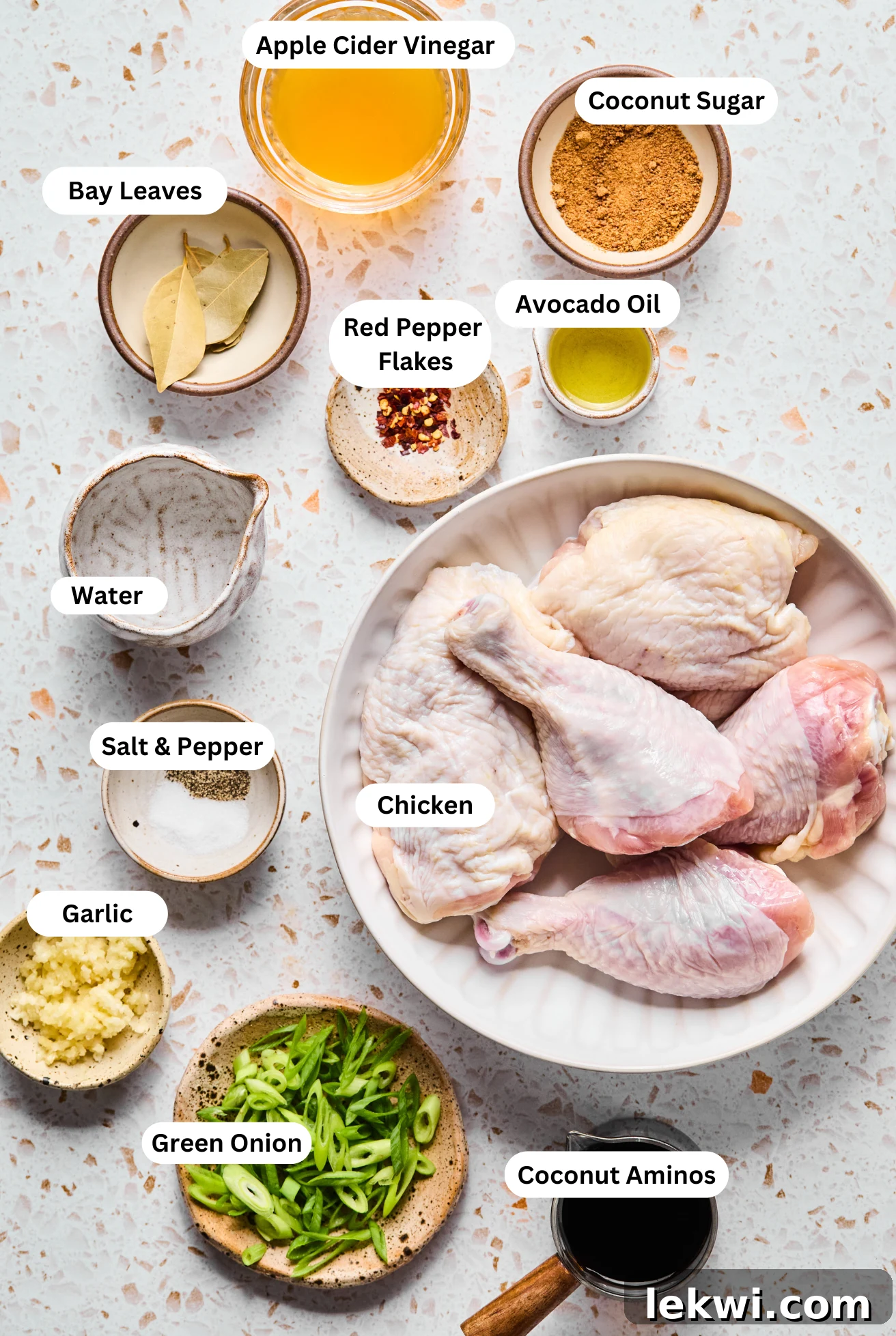 All the fresh ingredients meticulously arranged in small bowls, ready to be combined for Adobo Chicken.