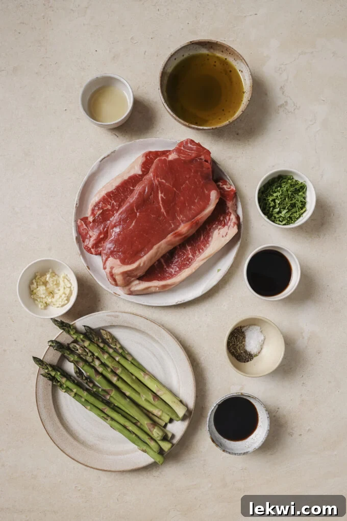 Garlic and balsamic steak bites with asparagus ingredients in separate bowls.