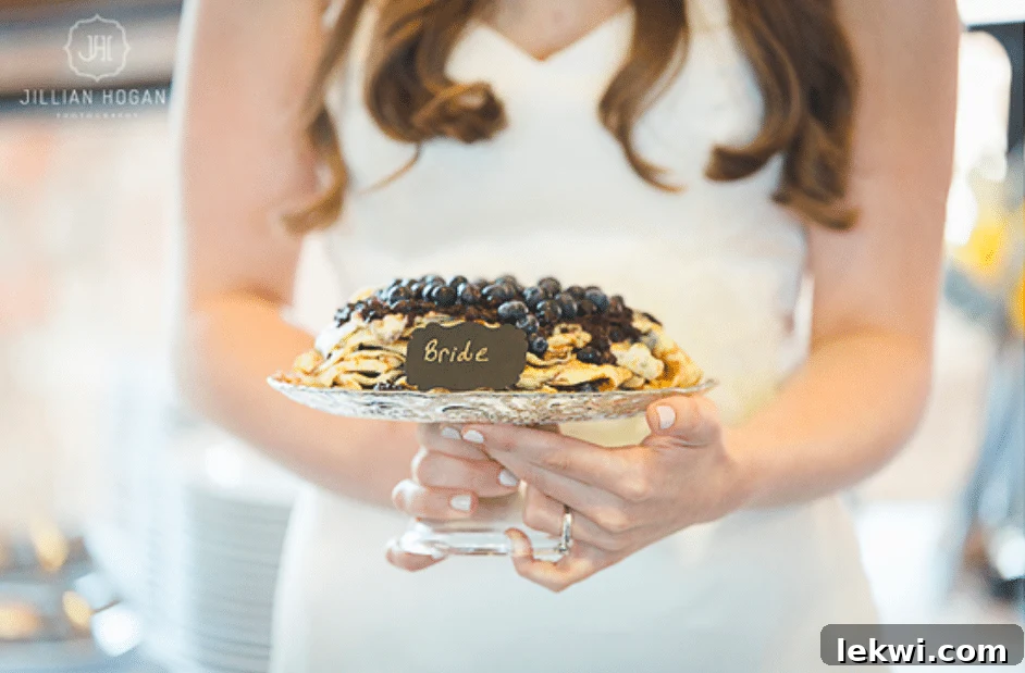 A bride holding a cake.