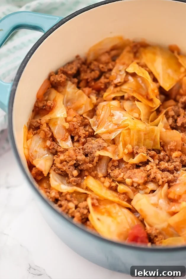 A Dutch oven filled with ground beef cabbage roll.
