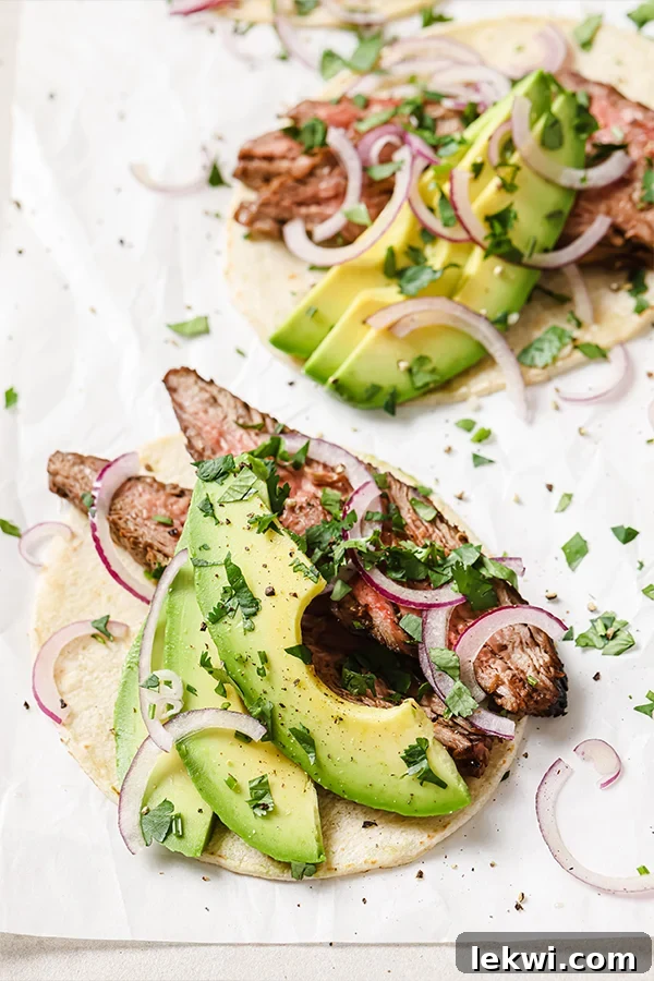Avocado, red onion, and carne asada on a tortilla.