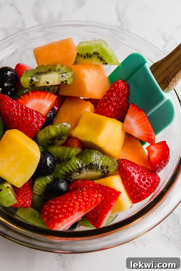 Freshly mixed fruit salad with honey, lime, and mint dressing