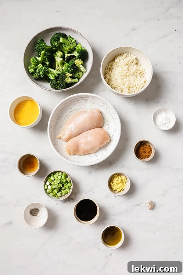 Key ingredients for orange chicken meal prep including fresh oranges, coconut aminos, apple cider vinegar, and arrowroot starch.