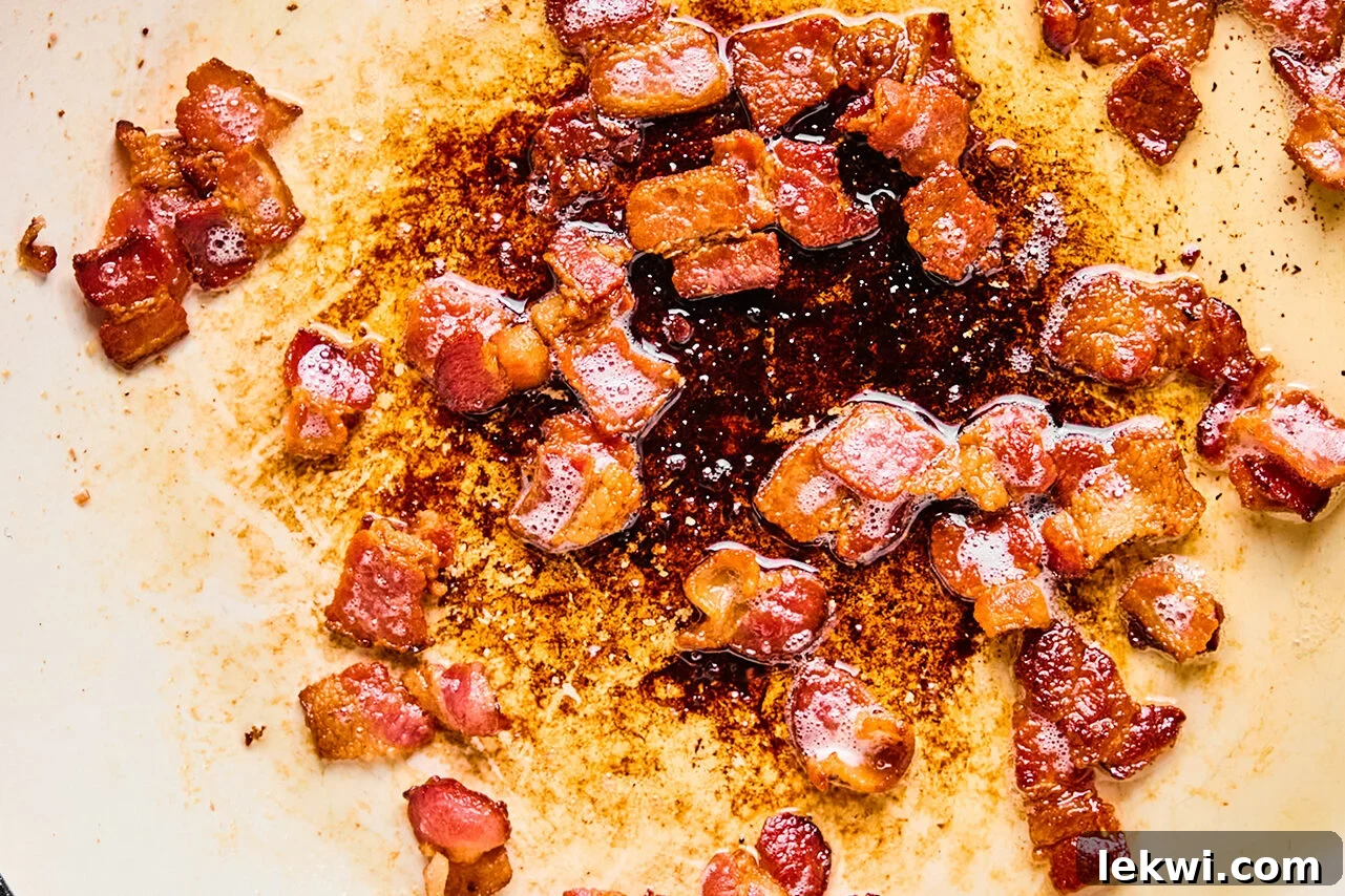 Bacon crisping in a pan.