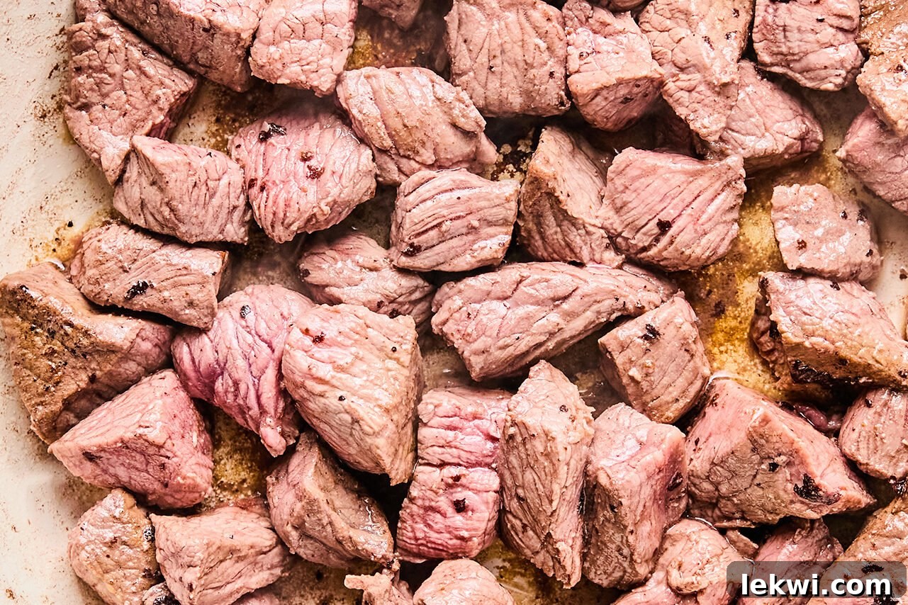 The beef browning in a skillet.
