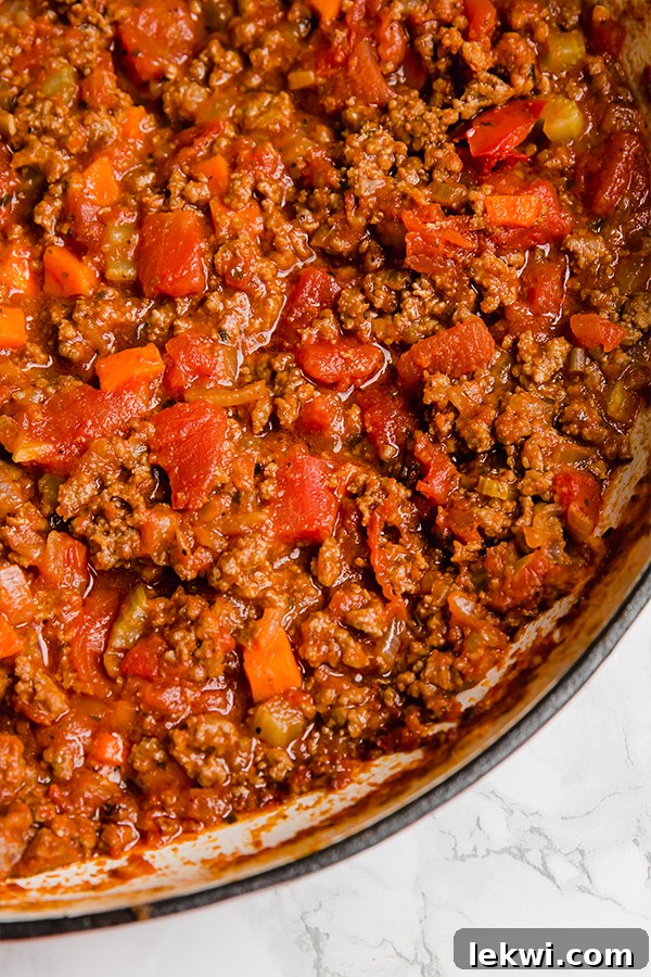A pot of bolognese sauce ready to be added to gnocchi.