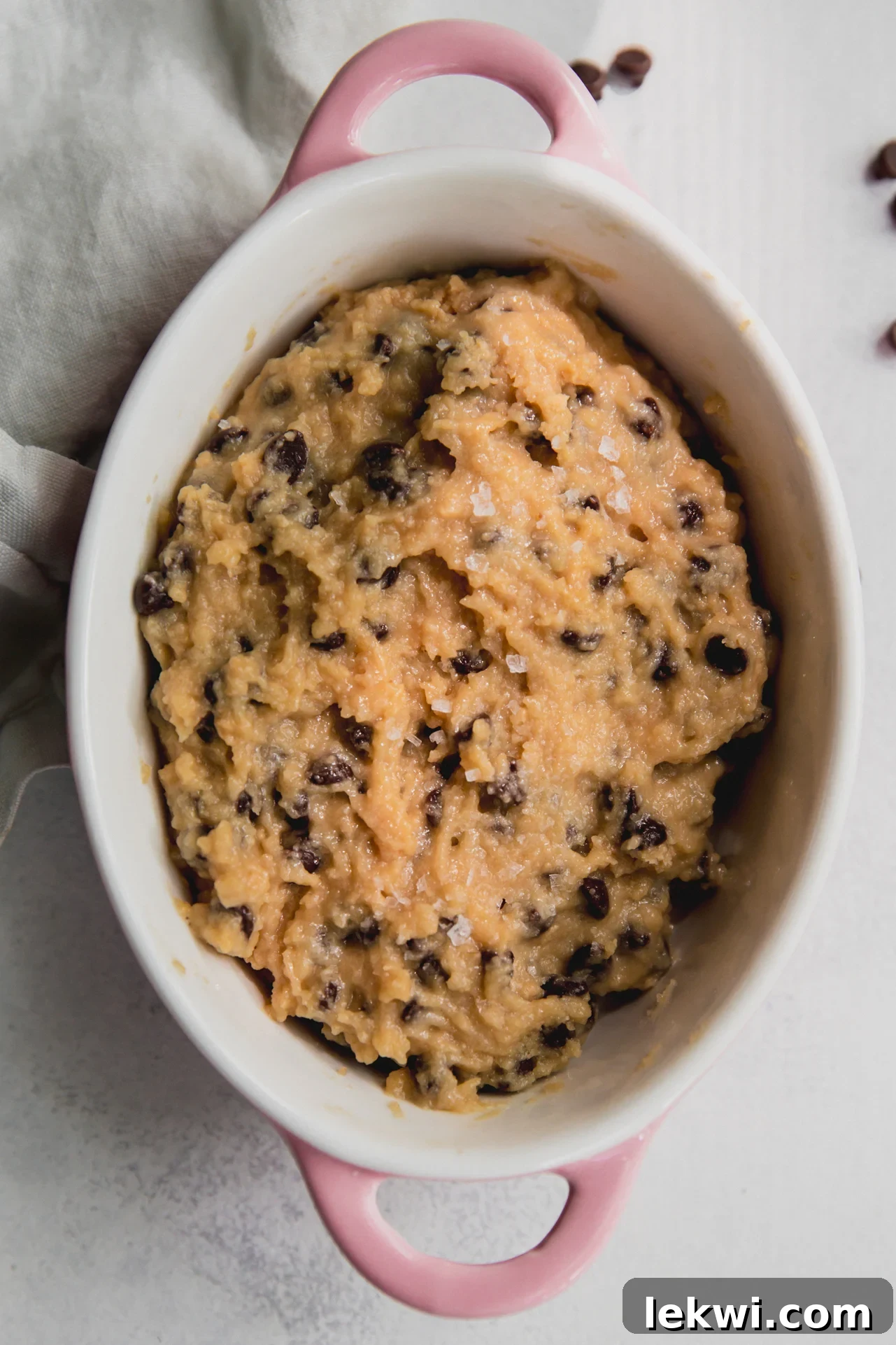 A scoop of high-protein, dairy-free cookie dough in a pink bowl.