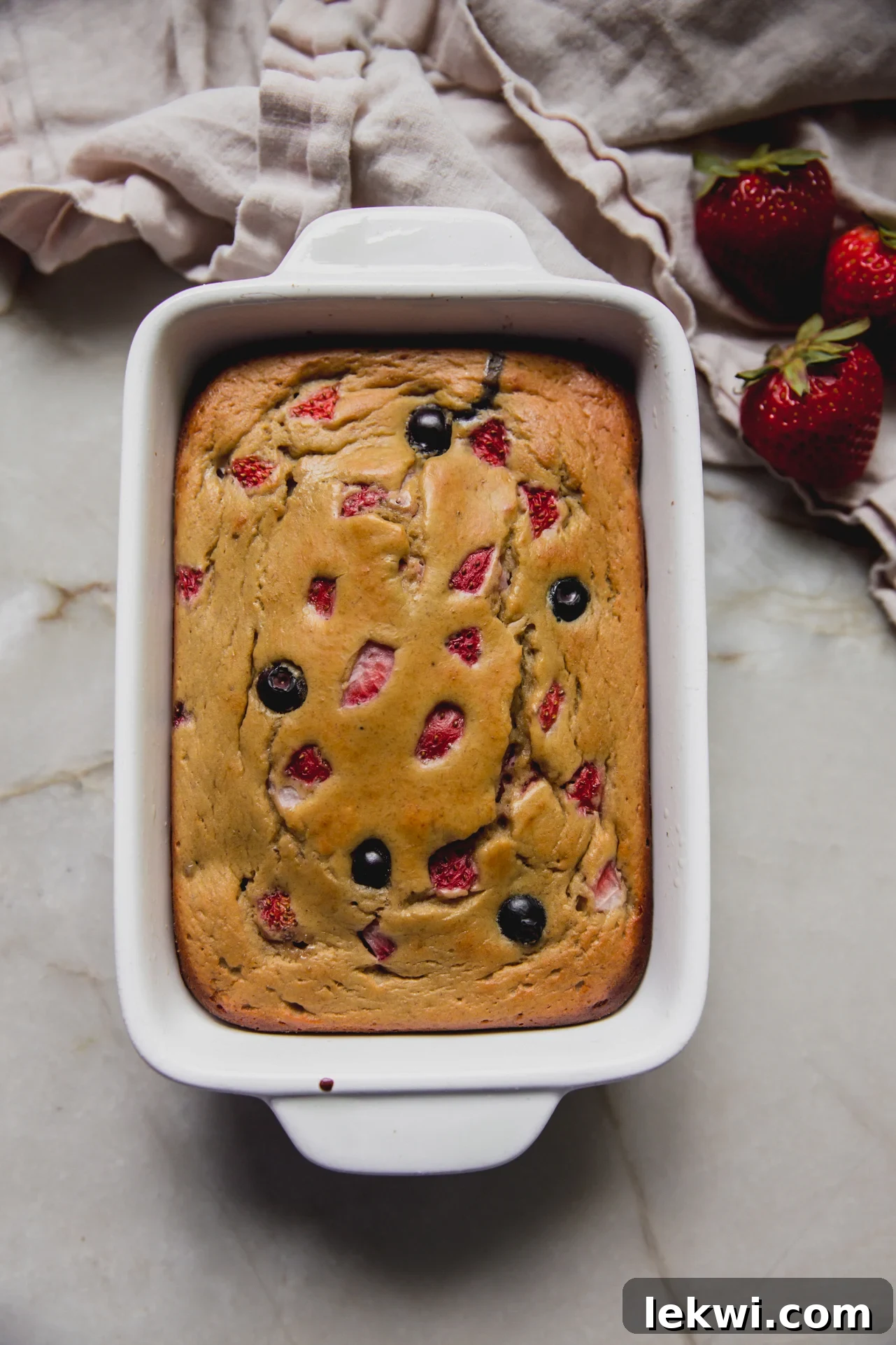 Berry Protein Breakfast Cake: High-Protein Morning Berries Bake 10 Berry protein breakfast cake in a small ceramic baking dish.