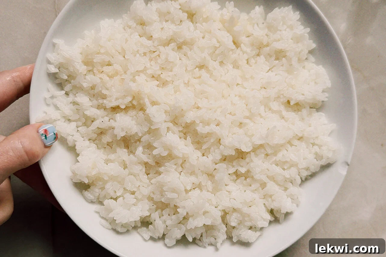A white bowl filled with rice mixed with vinegar.